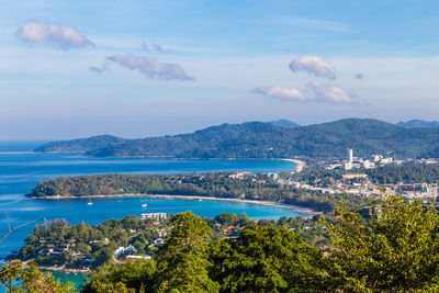 Scenic view of sea and mountains against sky