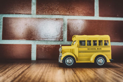 Close-up of toy car on table against wall