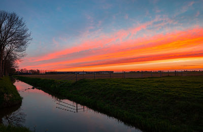 Red sunset over the dutch landscape caused by sahara sand in the atmosphere