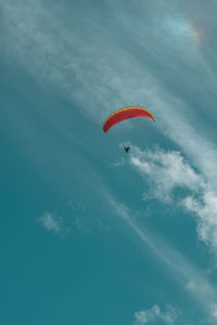 Low angle view of paragliding against sky