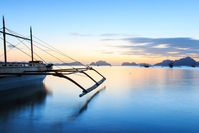 View of boats in calm sea at sunset