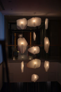 Illuminated light bulbs hanging from ceiling