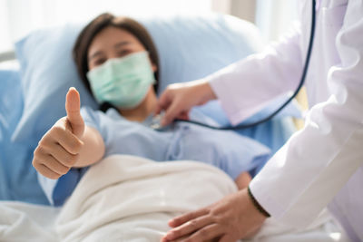 Midsection of man lying on bed