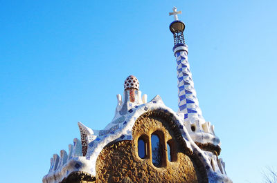 Low angle view of bell tower against blue sky