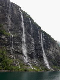 Low angle view of waterfall against sky