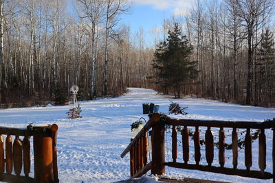 Scenic view of snow covered field against sky