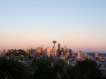 Modern buildings against clear sky at sunset