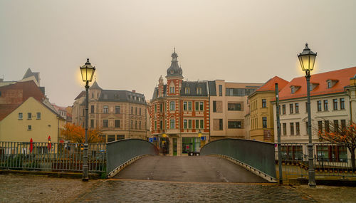 View of buildings in city against clear sky