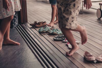 Low section of people on wooden floor