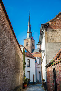 Low angle view of buildings against clear blue sky