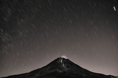 Scenic view of mountains against sky at night