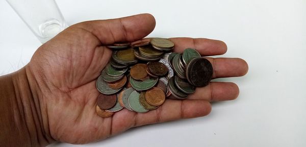 Close-up of hand holding coin