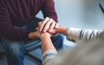 Midsection of man holding hands