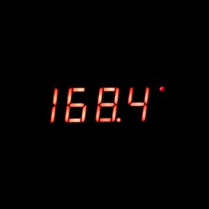 Close-up of illuminated clock in darkroom
