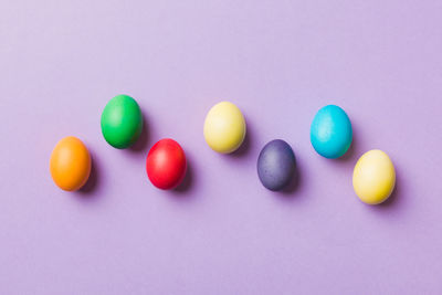 Close-up of multi colored easter egg on blue background
