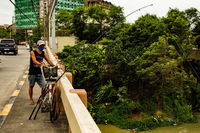 People riding bicycle on road in city