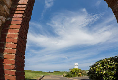 Low angle view of building against cloudy sky