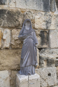 Low angle view of statue against wall at remains of the city of salamis