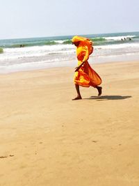 Full length of boy on beach against sky