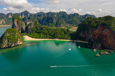 Aerial view seascape phra nang cave beach with traditional long tail boat sailing on the sea 