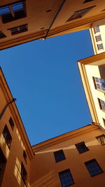 Low angle view of residential buildings against blue sky