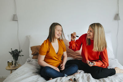 Young couple sitting on bed