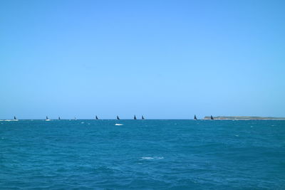 Scenic view of sea against clear blue sky