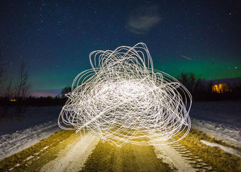 Light trails against sky at night