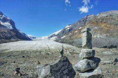 Scenic view of mountains against blue sky