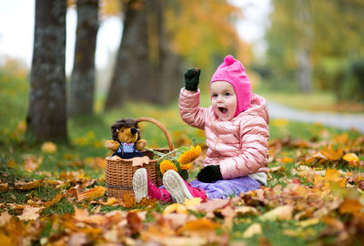 Girl sitting on autumn leaves