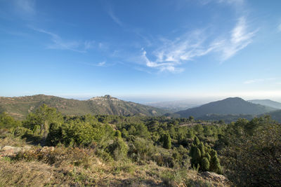 Scenic view of mountains against blue sky