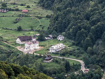 High angle view of houses amidst trees and buildings