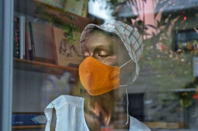 Portrait of man in glass window