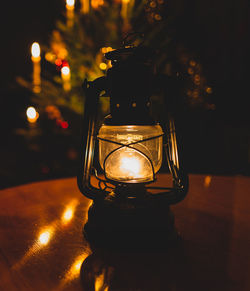 Close-up of illuminated light bulb on table