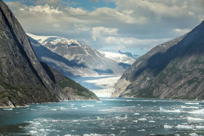 Scenic view of sea and mountains against sky