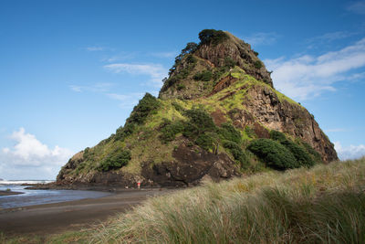 Rock formations by sea against sky