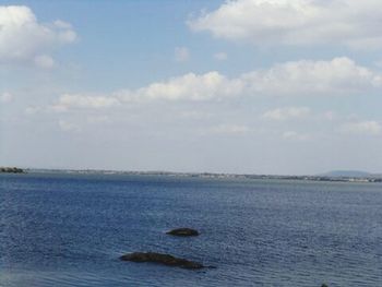 Scenic view of sea against cloudy sky