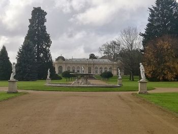 Built structure by trees against sky