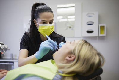 Female dentist with patient in office