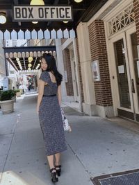 Full length of woman standing with umbrella