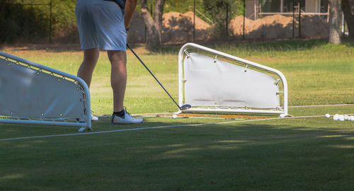 Low section of man playing golf