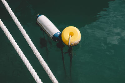 High angle view of rope tied floating on water