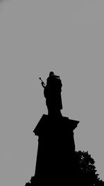 Silhouette of woman against sky