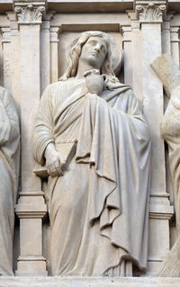 Saint john the apostle, statue on the facade of saint augustine church in paris, france