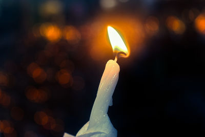 Close-up of lit candles in the dark