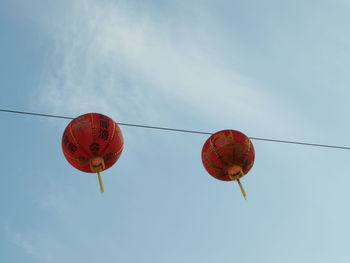 Low angle view of chinese lanterns hanging against sky