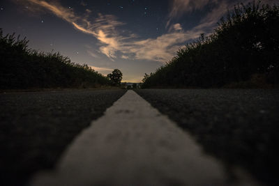 Surface level of empty road against the sky