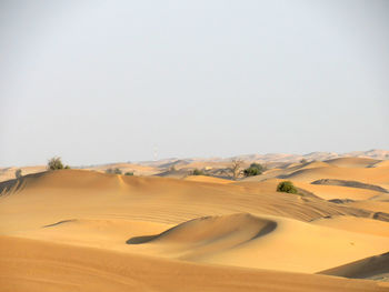 Idyllic shot of sand dunes in desert against clear sky