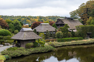 Built structure by lake against sky