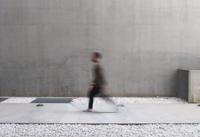 Blurred motion of man walking on floor